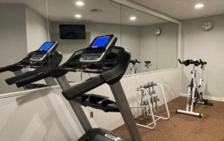 fitness center with exercise machines and free weights